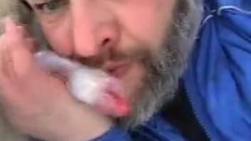 Mature bearded zoophile sucking on a dog's meaty cock