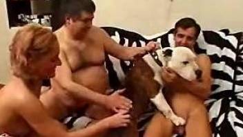 Horny guys along naked woman sharing dog cock in home zoophilia