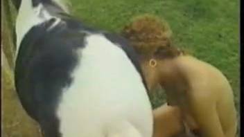 Curly-haired hottie screwing dogs and horses in the open air