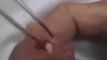 Guy gently placing larvae into his urinary passage