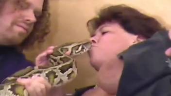 Amateur snake fetish zoo video featuring a curvy older woman in heat