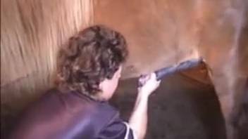 Sexy woman in leather attire pleasuring herself with large horse cocks